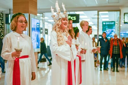 Norrkoping, Sweden - December 13, 2019: Traditional celebration of Saint Lucy in Sweden. Norrkopingâs Lucia 2019 Izabella Swartz singing Christmas carols in shopping mall Linden.のeditorial素材