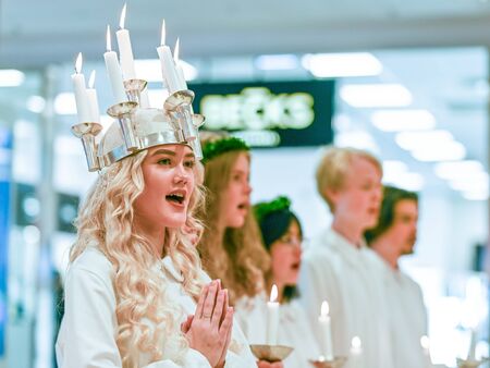 Norrkoping, Sweden - December 13, 2019: Traditional celebration of Saint Lucy in Sweden. Norrkopingâs Lucia 2019 Izabella Swartz singing Christmas carols in shopping mall Linden.のeditorial素材