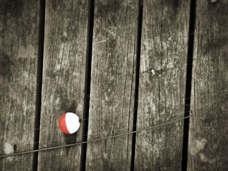 Fishing rod on old boardsの写真素材