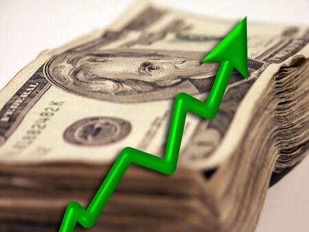 An upward moving arrow and USA moneyの写真素材