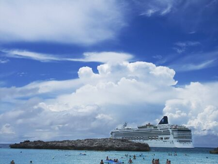 Cruise ship anchored near islandの写真素材