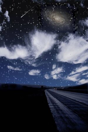 Single car travels on dark road under starsの写真素材