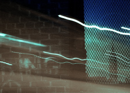 Empire State Building seen through a window with light trails