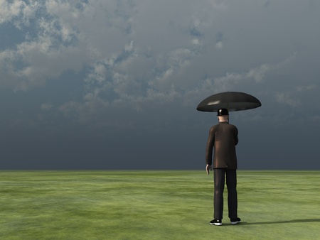 man with umbrella under cloudy skyの写真素材