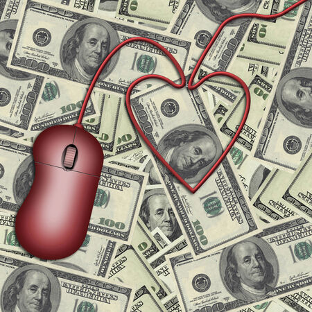 Computer mouse atop US currencyの写真素材