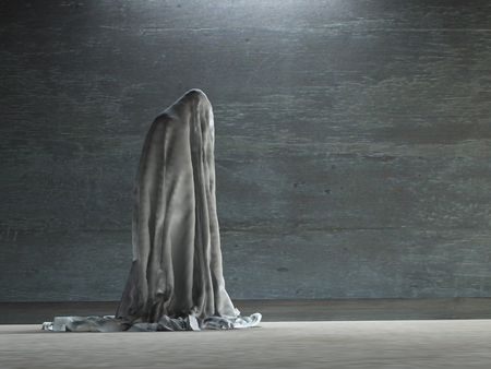 Figure hunched over under clothの写真素材