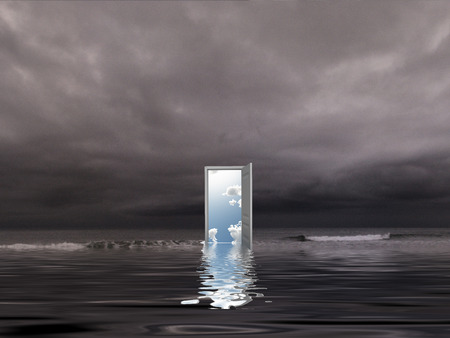 Opened door to another dimension on a seashore.の写真素材