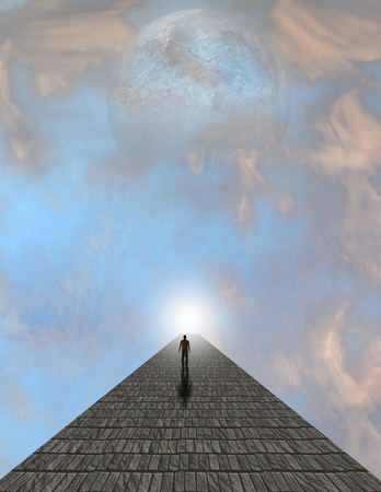 Man atop stone in cloudsの写真素材