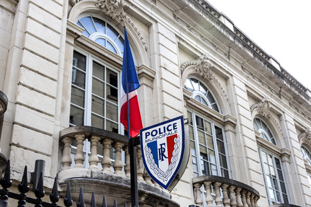France, Saone-et-Loire, Macon: Police station with sign and French national flag on an exterior wall of a public building - concept safety crime danger law help security government. August 05, 2017のeditorial素材