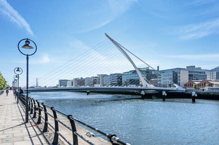 Ireland, Dublin: Street scene with famous Samuel Beckett Bridge called The Harp and river Liffey in the city center of the Irish capital with blue sky in the background. June 09, 2015のeditorial素材