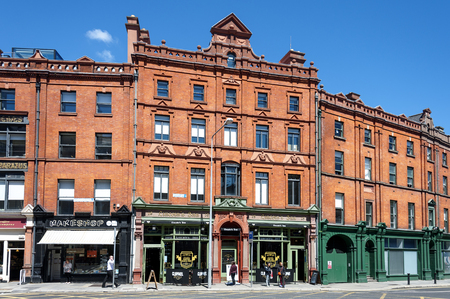 Ireland, Dublin: People residents tourists in front of Lincoln's Inn and traditional historic old red brick houses buildings on Lincoln Place in the city center of the Irish capital. June, 2015のeditorial素材
