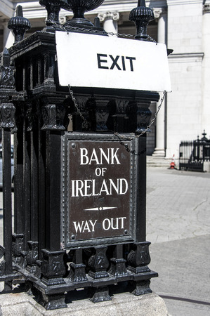 Ireland, Dublin: Street scene with Exit signs of Irish Bank of Ireland Exit Way Out - concept bank money business finicial crisis risk bankruptcy. June 09, 2015のeditorial素材