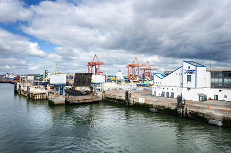 Ireland, Dublin, International Port: Quay wall of Irish harbor, cranes and harbour buildings -...