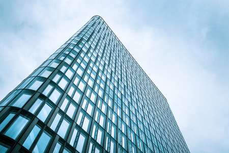 Green colored skyscraper, panorama of modern high-rise building against the cloudy sky view from...