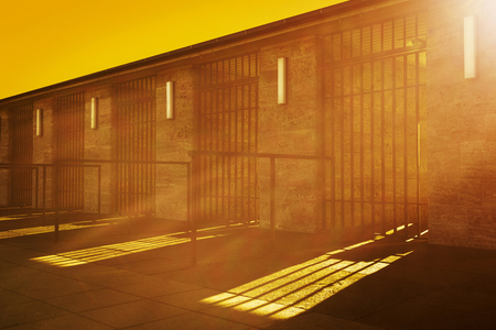 Mystic scene - sunbeams shine through metal fence entrance, orange red with dark shadowsの写真素材