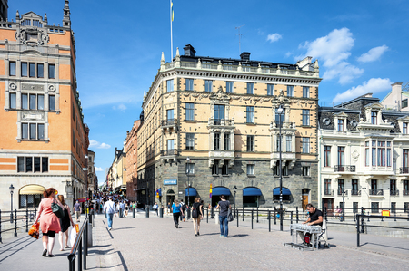 Sweden, Stockholm: People tourists residents man woman on famous Bridge Riksbron with musician in the city center of the Swedish capital. August 08, 2014のeditorial素材