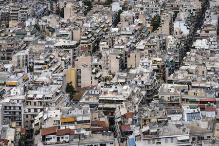 Greece, Athens: Skyline with mass of houses, buildings, apartments, rooftops in the city center of Greek capital - concept urban development town planning structure living condition. April 30, 2018のeditorial素材