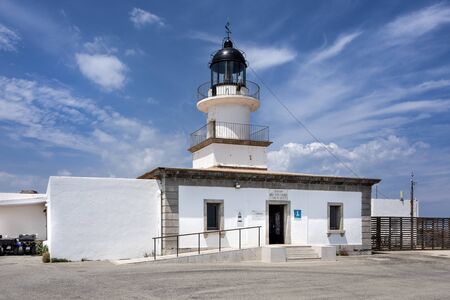 Spain, Catalonia, Cap de Creus: Panorama view of famous Spanish tourist destination with white lighthouse and cloudy sky in the background - concept travel navigation destination. June 28, 2018のeditorial素材