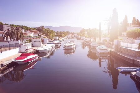 Spain, Catalonia, Costa Brava, Empuriabrava: Panorama view against sun with yachts, boats, waterways, blue sky. The Spanish tourist destination has the largest residential marina. June 29, 2018のeditorial素材