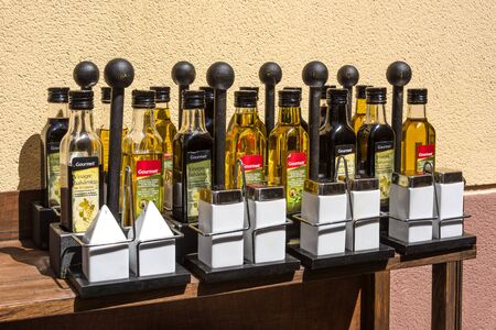 North of Spain, Catalonia: Group of condiment dispenser sets with oil, salt, pepper, oil in jars and bottles - concept food dish spice restaurant bar organic catering taste lunch dinner. June 29, 2018のeditorial素材