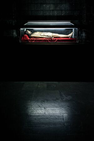 Spain, Figueres, near Dali Theatre and Museum: Lying religious figure in an illuminated shrine sarcophagus of famous Iglesia de San Pedro - St. Peter's church in the city center. Juliy 27, 2018のeditorial素材