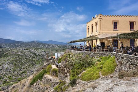 Spain, Catalonia, Cap de Creus: Panorama view of famous Spanish tourist destination with people in a restaurant, mountains, horizon and blue sky in the background - concept travel. June 28, 2018のeditorial素材