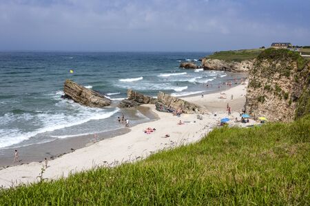 Spain, Galicia, near Ribadeo: Panorama view with people tourists residents at the famous beautiful near Beach of Cathedrals (Playa de las Catedrales) with cliffs, ocean, skyline. July 15, 2018のeditorial素材