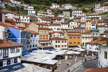 Spain, Asturias, Cudillero, Cuideiru: Skyline with people tourists and colorful traditional houses in the city center of the Spanish village. Legend says it was founded by the Vikings. July 15, 2018のeditorial素材