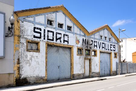 Spain, Asturias, Villaviciosa: Street scene with front facade of a closed traditional cider (Sidra) production in city center. The Spanish town is known as capital of cider production. July 16, 2018のeditorial素材