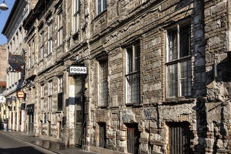 Hungary, Budapest, Akacfa: Street scene with run down front facade of famous popular ruin bar pub Fogas Haz (Toothy House) in the city center of the Hungarian capital - concept nightlife. Feb 07, 2019のeditorial素材