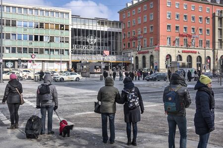 Germany, Bavaria, Munich, Central Station: Street scene with people residents tourists travellers in front of  German train bus taxi station in the city center of Bavarian capital. February 27, 2018のeditorial素材