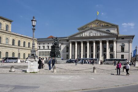 Germany, Bavaria, Munich, Max-Joseph-Platz: People tourists residents visit the Max Joseph square in the center of the Bavarian capital with National Theater in the background. April 22, 2016のeditorial素材