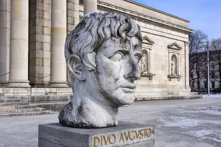Germany, Bavaria, Munich, Koenigsplatz: Entrance of famous Glyptothek museum at winter time with sculpture head, facade, snow and blue sky in the city center of the Bavarian capital. March 01, 2018のeditorial素材