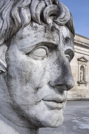 Germany, Bavaria, Munich, Koenigsplatz: Close up of sculpture head in front of famous Glyptothek at winter time with front facade and blue sky in the city center of Bavarian capital. March 01, 2018のeditorial素材