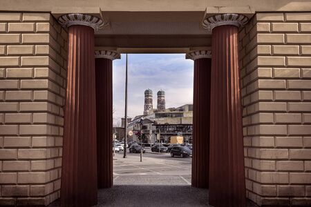 Germany, Bavaria, Munich, near Bayerisches Justizministerium: Unique view through entrance portal of famous old Botanical Garden to famous Frauenkirche in center of Bavarian capital. March 01, 2018のeditorial素材
