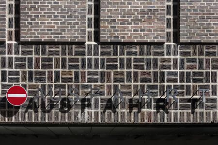 Exit ramp with capitals and German traffic sign 'No Entry' on a wall of a parking garage - concept closed traffic forbidden car parkの写真素材