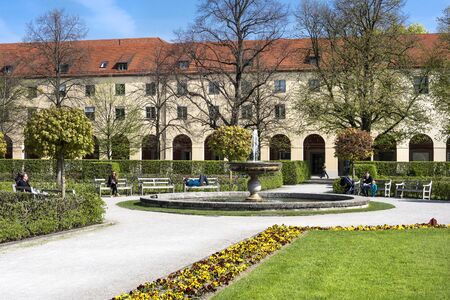 Germany, Bavaria, Munich, Hofgarten: People toursits residents women men relax in famous Court Garden and water fountain in the city center of the Bavarian capital. April 22, 2016のeditorial素材
