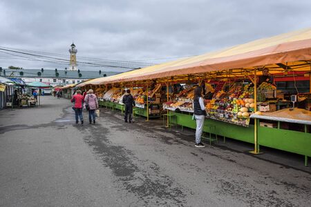 Russia, Golden Ring, Kostroma, near Susanin Square: Famous Shopping Arcades (Ranks) with people at the Central Market and fire observation watchtower in the background - daily needs. Jul 05, 2019のeditorial素材