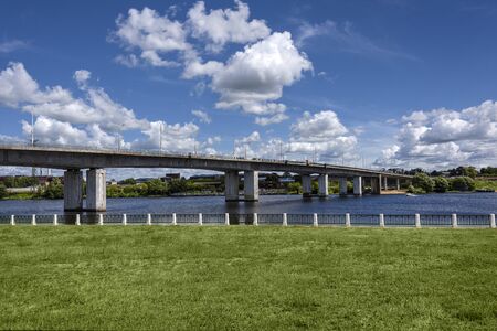 Russia, Golden Ring, Kostroma: Panorama with big bridge over Kostroma River near famous Ipatievsky Monastery near the city center of the Russian town with blue cloudy sky - traffic. Jul 05, 2019のeditorial素材
