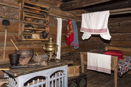 Russia, Republic of Karelia, Kizhi Island: Inner view of traditional historical wooden building habitation of Russian orthodox people with table, samovar, kitchen appliances, cupboard. Jul 10, 2019のeditorial素材