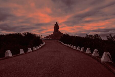 Russia, Murmansk, Barents Sea: Famous Alyosha Monument to Soviet soldiers, sailors and airmen of World War II (Great Patriotic War 1941-1945) against sun with dramatic blood red sky. July 15, 2019のeditorial素材