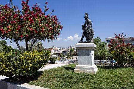 Greece, Athens: Statue in a green public park near metro station Thissio in the city center of the Greek capital with people residents tourists trees and blue sky in the background. April 26, 2018のeditorial素材