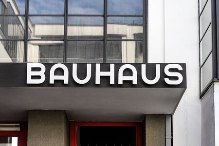 Germany, Saxony-Anhalt, Dessau-Rosslau: Bauhaus building exterior view with famous text logo over main entrance, red door, windows, front facade - concept modern architecture art school. Dec 30, 2019のeditorial素材