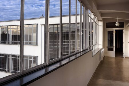 Germany, Saxony-Anhalt, Dessau-Rosslau: Bauhaus building interior view with hallway, famous glass windows, offices and exterior front facade - concept modern architecture art school. Dec 30, 2019のeditorial素材