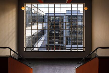 Germany, Saxony-Anhalt, Dessau-Rosslau: Bauhaus building interior view with famous glass windows, stairways stairwell, offices, front facade - concept modern architecture art school. Dec 30, 2019のeditorial素材