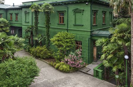Russia, Sochi: Courtyard of Joseph Stalin's dacha villa cottage near the city center of the famous Russian town with green facade, garden - travel history museum summer residence. Jun 27, 2019のeditorial素材
