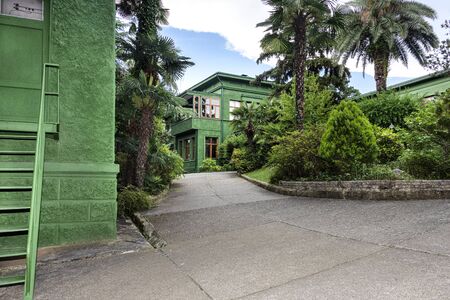 Russia, Sochi: Courtyard of Joseph Stalin's dacha villa cottage near the city center of the famous Russian town with green facade, garden - travel history museum summer residence. Jun 27, 2019のeditorial素材