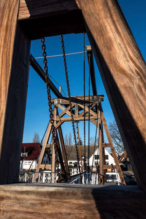 Germany, Greifswald, Wieck - December 30, 2016: Details of traditional wooden draw bridge and houses in the background. The bridge crosses river Ryck and has been build in 1887.のeditorial素材