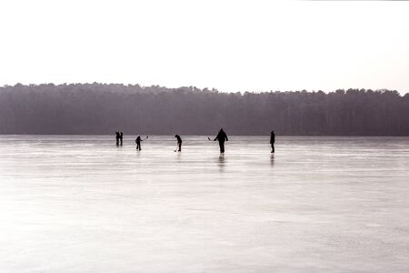 Panorama view of a frozen lake with people on the ice.の写真素材