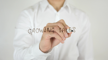 Growing Sales, Written on Glass by Man in Studioの写真素材